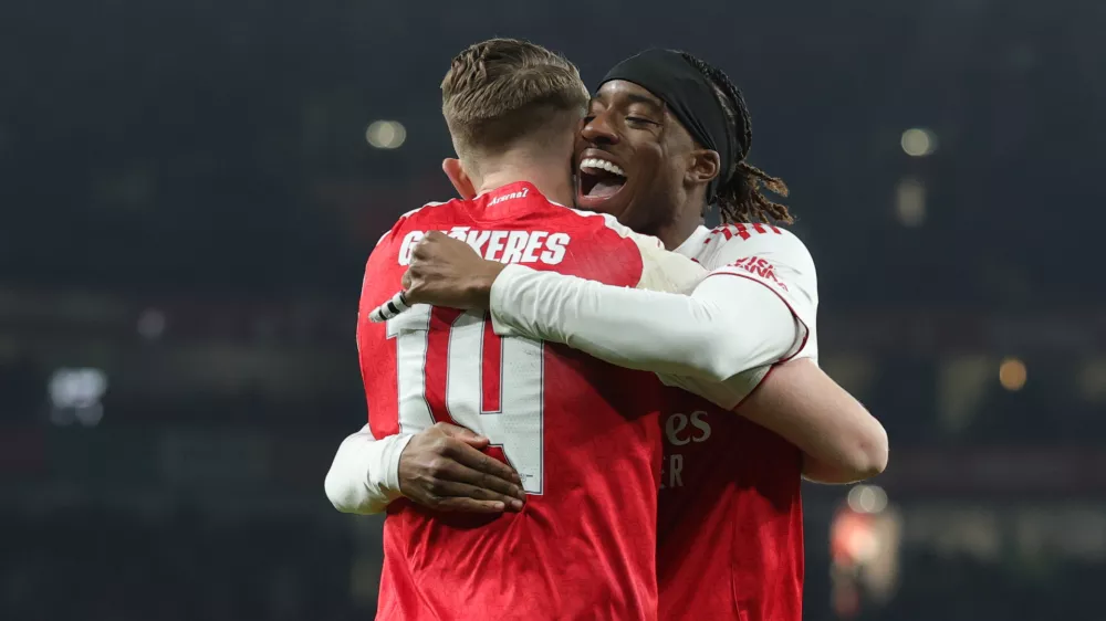 Arsenal's Viktor Gyoekeres, left, celebrates after scoring his side's opening goal with his teammate Noni Madueke during the Champions League opening phase soccer match between Arsenal and Kairat Almaty in London, Wednesday, Jan. 28, 2026. (AP Photo/Ian Walton)