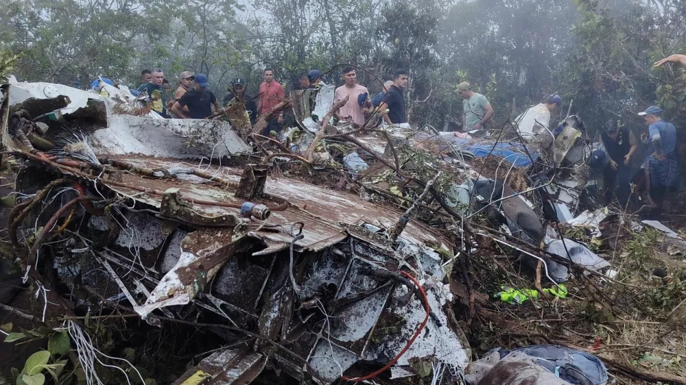 People stand near the wreckage of a plane crash in Playa de Belen, North Santander Colombia, January 28, 2026, in this picture obtained from social media. Notiplaya/via REUTERS THIS IMAGE HAS BEEN SUPPLIED BY A THIRD PARTY. MANDATORY CREDIT Verification lines:The location of the footage was confirmed from the source and authorities report of the plane crash. Reuters was also able to confirm the airline logo, colors and pattern of debris from wreckage that matched the SEARCA plane from file images. The date of footage was verified from original file metadata. FlightRadar24.com showed the flight taking off from Camilo Daza International Airport at around 16:40UTC and flew towards Ocana before disappearing on the radar at around 16:54UTC.
