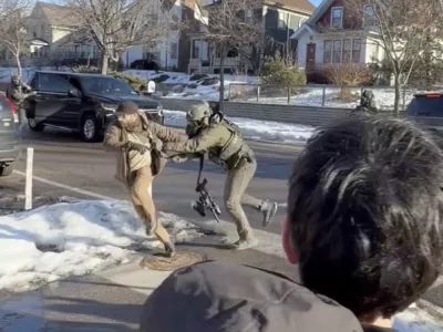 This image taken from video by Max Shapiro shows Alex Pretti, left, scuffling with federal immigration officers in Minneapolis on Jan. 13, 2026. (Max Shapiro via AP)