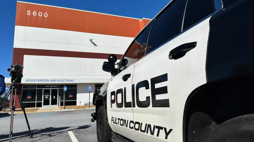 Police vehicles are seen outside the Fulton County elections hub in Union City, Ga., Wednesday, Jan. 28, 2026. (AP Photo/Emilie Megnien)