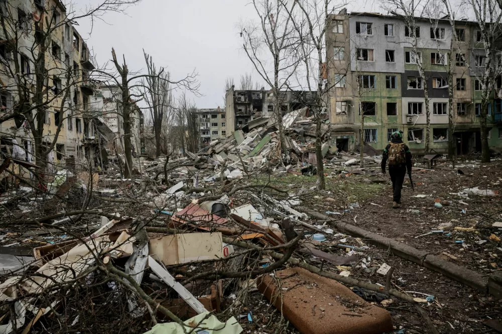 Ukrainian serviceman walks near apartment buildings damaged by Russian military strike, amid Russia's attack on Ukraine, in the frontline town of Kostiantynivka in Donetsk region, Ukraine December 20, 2025. Oleg Petrasiuk/Press Service of the 24th King Danylo Separate Mechanized Brigade of the Ukrainian Armed Forces/Handout via REUTERS ATTENTION EDITORS - THIS IMAGE HAS BEEN SUPPLIED BY A THIRD PARTY.