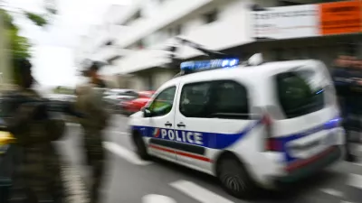 24 April 2025, France, Nantes: A police car drives to the Notre-Dame de Toutes-Aides secondary school, where one pupil has been killed and three others injured in a knife attack. Photo: Loic Venance/AFP/dpa
