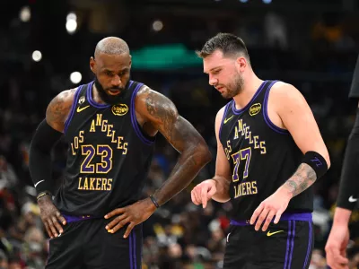Jan 30, 2026; Washington, District of Columbia, USA; Los Angeles Lakers forward/guard Luka Doncic (77) talks with Los Angeles Lakers forward LeBron James (23) against the Washington Wizards during the second half at Capital One Arena. Mandatory Credit: Brad Mills-Imagn Images