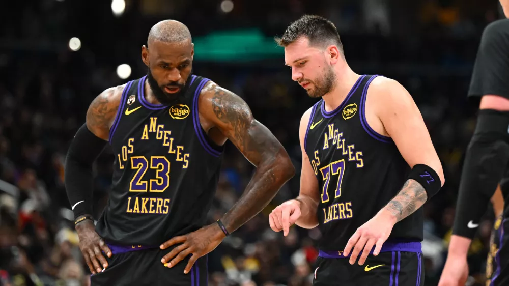 Jan 30, 2026; Washington, District of Columbia, USA; Los Angeles Lakers forward/guard Luka Doncic (77) talks with Los Angeles Lakers forward LeBron James (23) against the Washington Wizards during the second half at Capital One Arena. Mandatory Credit: Brad Mills-Imagn Images