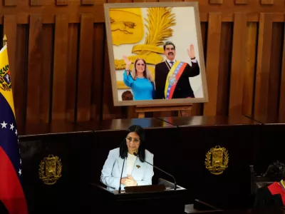 Venezuelan acting President Delcy Rodriguez speaks under a framed image of former President Nicolas Maduro and his wife Cilia Flores, during a ceremony marking the opening of the new judicial year at the Supreme Tribunal of Justice in Caracas, Venezuela, Friday, Jan. 30, 2026. (AP Photo/Ariana Cubillos)