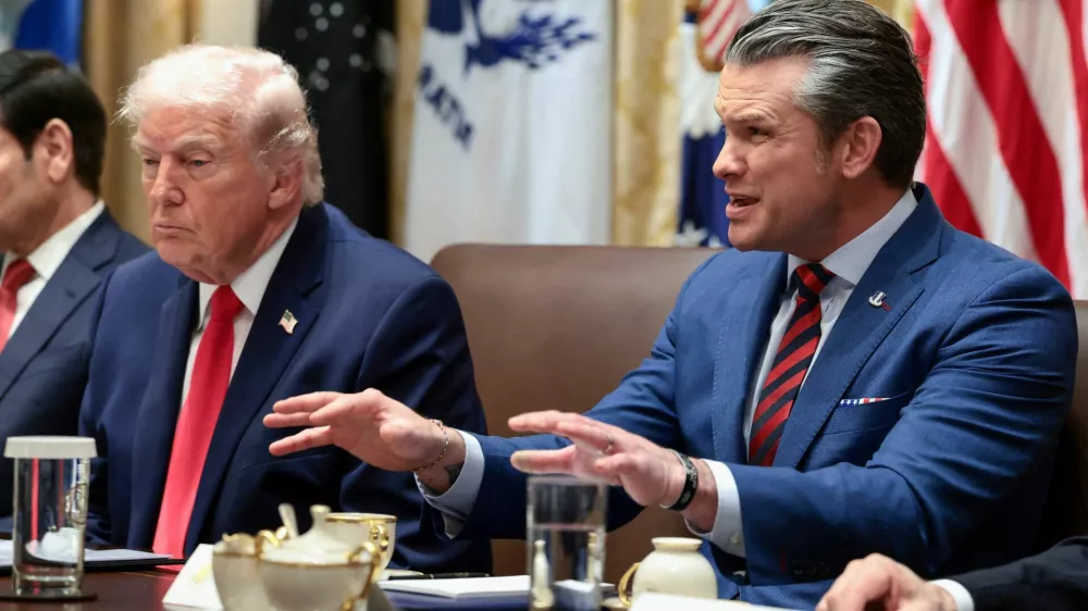 FILE PHOTO: U.S. Defense Secretary Pete Hegseth speaks next to President Donald Trump during a cabinet meeting at the White House in Washington, D.C., U.S., January 29, 2026. REUTERS/Evelyn Hockstein/File Photo