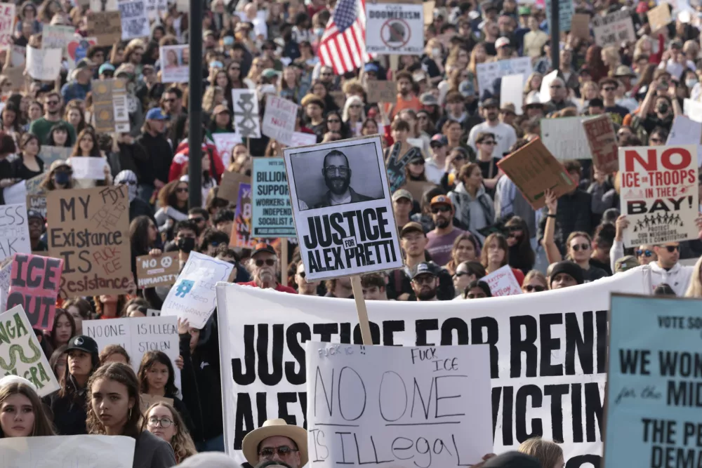EDS NOTE: OBSCENITY - People gather at Dolores Park as part of a nationwide shutdown effort in response to the ongoing federal immigration raids and unrest in Minneapolis, in San Francisco on Friday, Jan. 30, 2026. (Yalonda M. James/San Francisco Chronicle via AP)