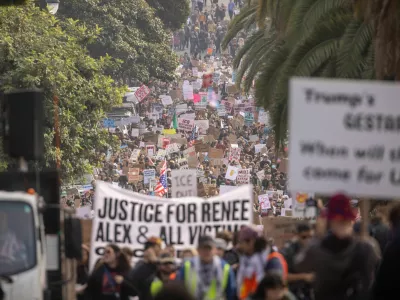 EDS NOTE: OBSCENITY - Protesters march at Dolores Park during a nationwide shutdown and walkout in protest against the ongoing federal immigration raids and unrest in Minneapolis, in San Francisco, Friday, Jan. 30, 2026. (Stephen Lam/San Francisco Chronicle via AP)
