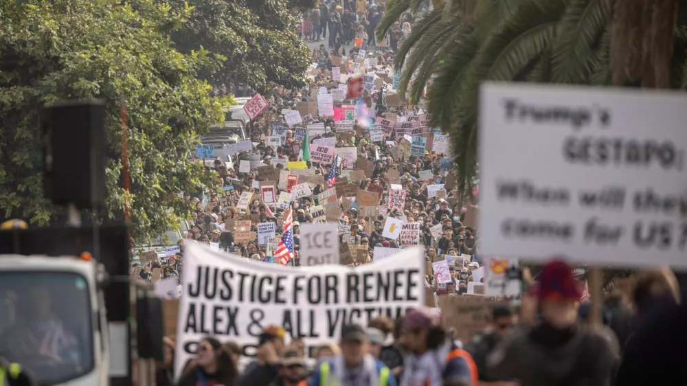 EDS NOTE: OBSCENITY - Protesters march at Dolores Park during a nationwide shutdown and walkout in protest against the ongoing federal immigration raids and unrest in Minneapolis, in San Francisco, Friday, Jan. 30, 2026. (Stephen Lam/San Francisco Chronicle via AP)