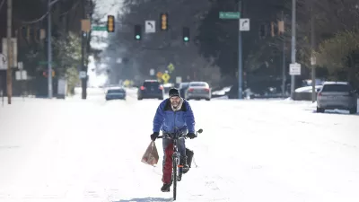 Jean Christophe rides his bike home from Kroger on snow and ice in Memphis, Tenn., Wednesday, Jan. 28, 2026. (Mark Weber/Daily Memphian via AP)