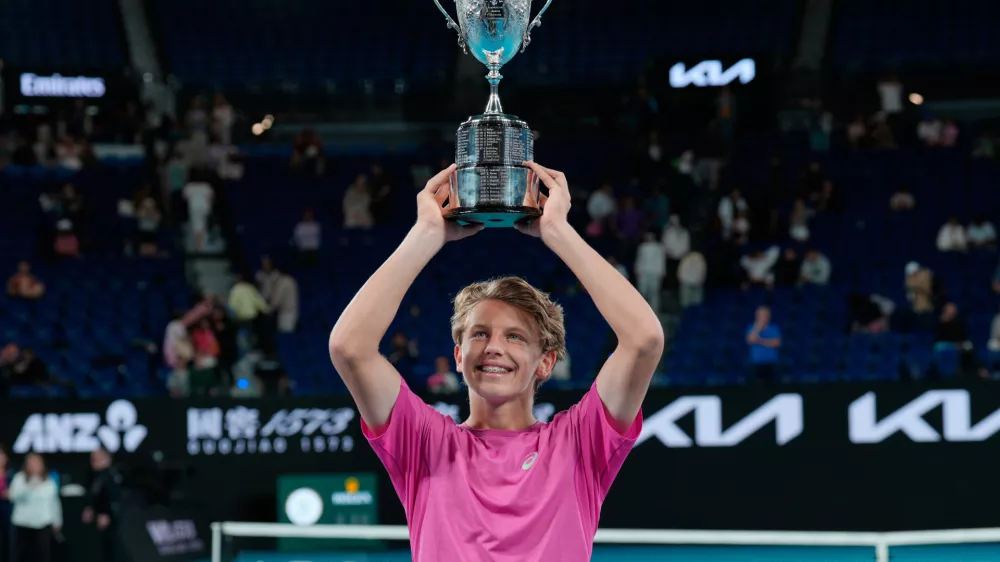 Ziga Sesko of Slovenia holds his trophy aloft after defeating Keaton Hance of the U.S. in the boy's singles final at the Australian Open tennis championship in Melbourne, Australia, Sunday, Feb. 1, 2026. (AP Photo/Dar Yasin)