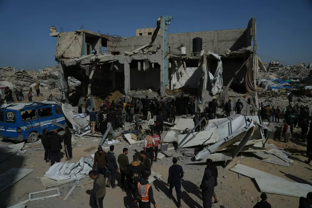 Palestinians search for bodies and survivors from the rubble of a police station after it was targeted by an Israeli army strike in Gaza City Saturday, Jan. 31, 2026. (AP Photo/Jehad Alshrafi)
