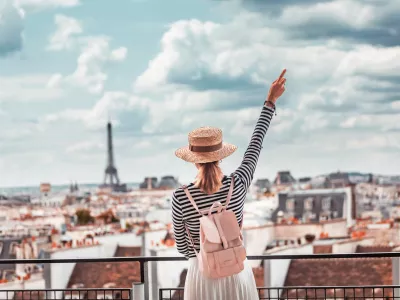 Happy Asian girl enjoys a Grand view of Paris from the height of the observation deck