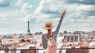 Happy Asian girl enjoys a Grand view of Paris from the height of the observation deck