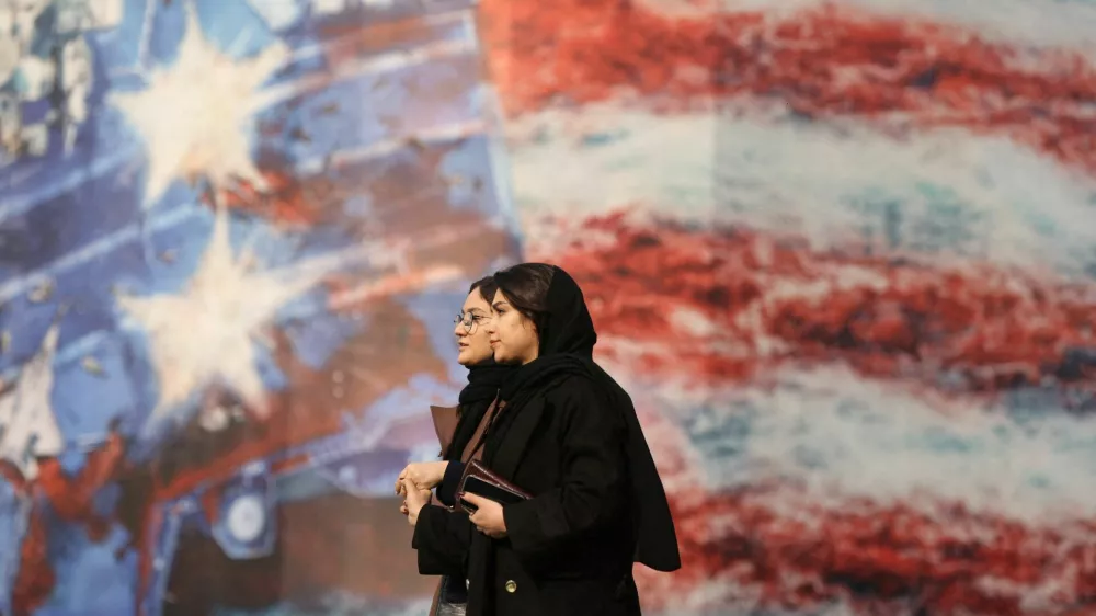 People walk past an anti-U.S. billboard in Tehran, Iran, January 26, 2026. Majid Asgaripour/WANA (West Asia News Agency) via REUTERS ATTENTION EDITORS - THIS PICTURE WAS PROVIDED BY A THIRD PARTY   TPX IMAGES OF THE DAY