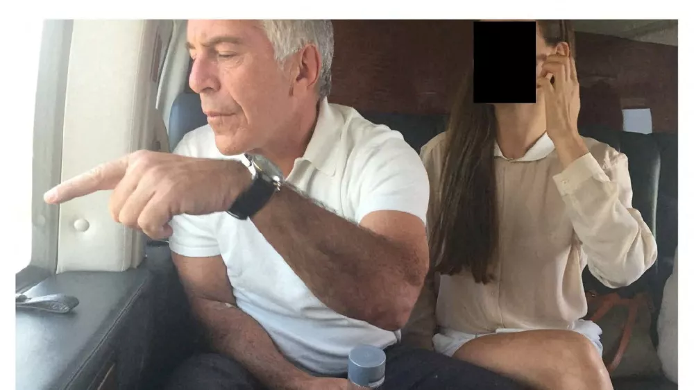 Late financier and convicted sex offender Jeffrey Epstein appears with a woman, whose identity has been obscured, in this image from the Epstein estate released by House Oversight Committee Democrats in Washington, D.C., U.S., on December 18, 2025. House Oversight Committee Democrats/Handout via REUTERS THIS IMAGE HAS BEEN SUPPLIED BY A THIRD PARTY. REDACTED AREA FROM SOURCE.   TPX IMAGES OF THE DAY