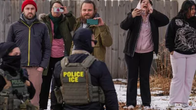 Observers film while federal agents conduct immigration enforcement operations, on Thursday, Feb. 5, 2026, in Minneapolis. (AP Photo/Ryan Murphy)