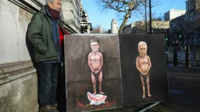 Artist Kaya Mar stands next to his satirical paintings depicting nude figures of British Prime Minister Keir Starmer and Andrew Mountbatten‑Windsor, the younger brother of Britain's King Charles, formerly Prince Andrew, Duke of York, as pressure builds on him to give evidence following the release of new U.S. Justice Department records linked to the late financier and convicted sex offender Jeffrey Epstein, titled "Mandy" and "Andy," on Downing Street in London, Britain, February 4, 2026. REUTERS/Toby Melville