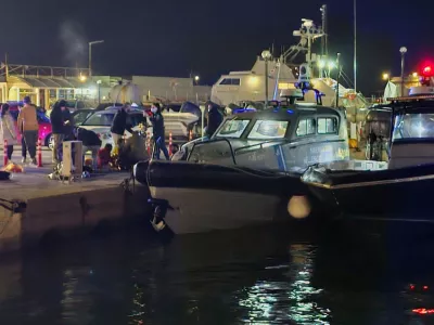 Greek coast guard officers carry out rescue operations at a port on the eastern Aegean island of Chios, Greece, late Tuesday, Feb. 3, 2026, after a collision between a migrant speedboat and a coast guard patrol vessel killed multiple people, authorities said. (Pantelis Fykaris/Politischios.gr via AP)