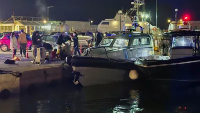 Greek coast guard officers carry out rescue operations at a port on the eastern Aegean island of Chios, Greece, late Tuesday, Feb. 3, 2026, after a collision between a migrant speedboat and a coast guard patrol vessel killed multiple people, authorities said. (Pantelis Fykaris/Politischios.gr via AP)