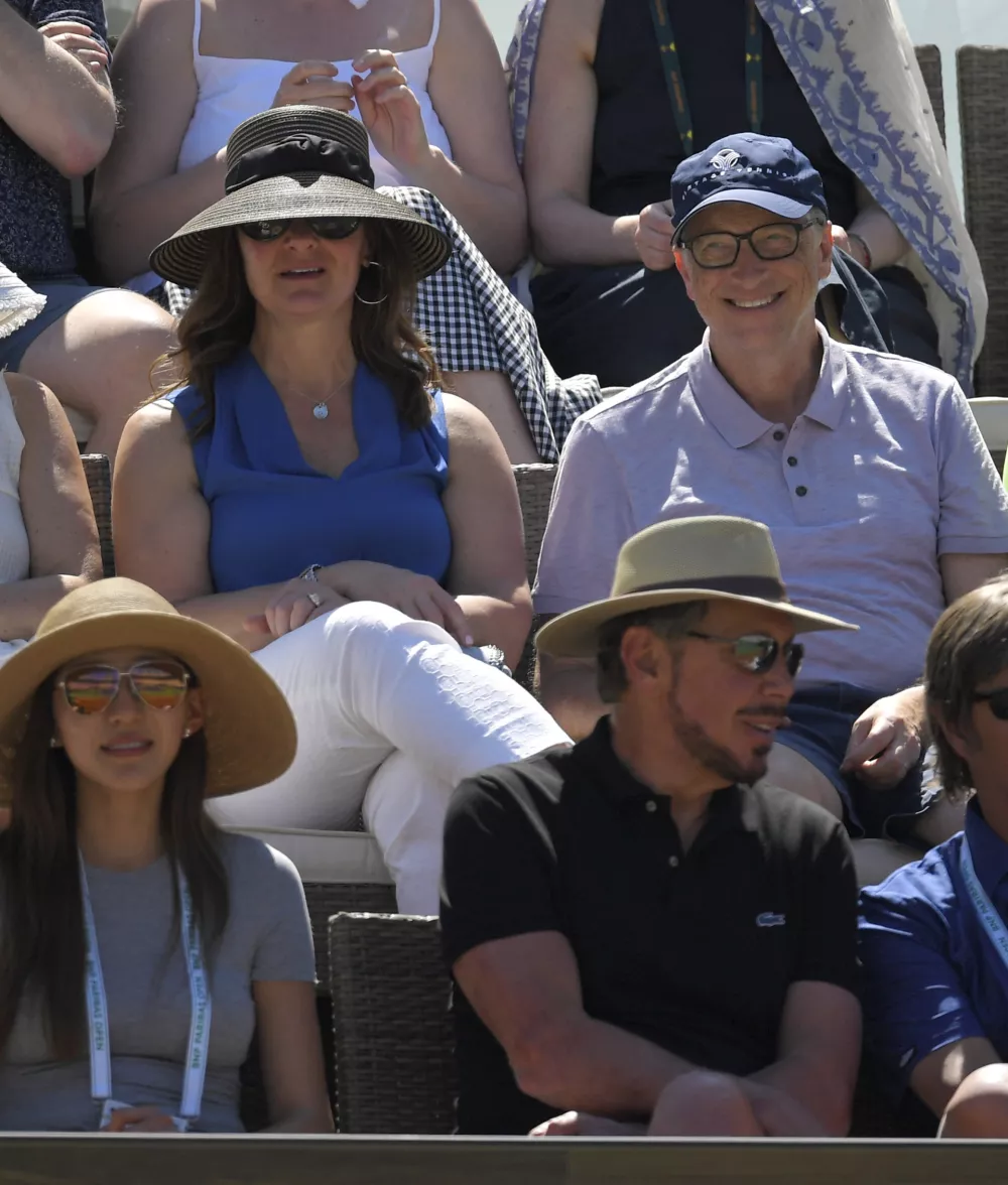 Bill Gates, upper right, and Melinda Gates, upper left, watch along with Oracle co-founder Larry Ellison, lower right, during a semifinal match at the BNP Paribas Open tennis tournament between Roger Federer and Jack Sock, Saturday, March 18, 2017, in Indian Wells, Calif. (AP Photo/Mark J. Terrill)