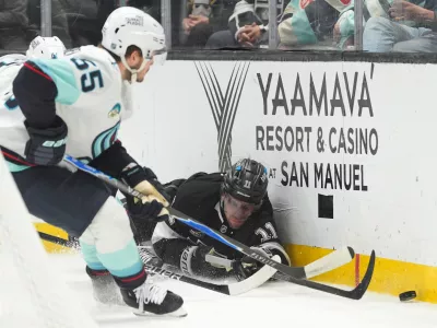 Los Angeles Kings center Anze Kopitar (11) falls to the ice while chasing the puck during the second period of an NHL hockey game against the Seattle Kraken Wednesday, Feb. 4, 2026, in Los Angeles. (AP Photo/Jae C. Hong)