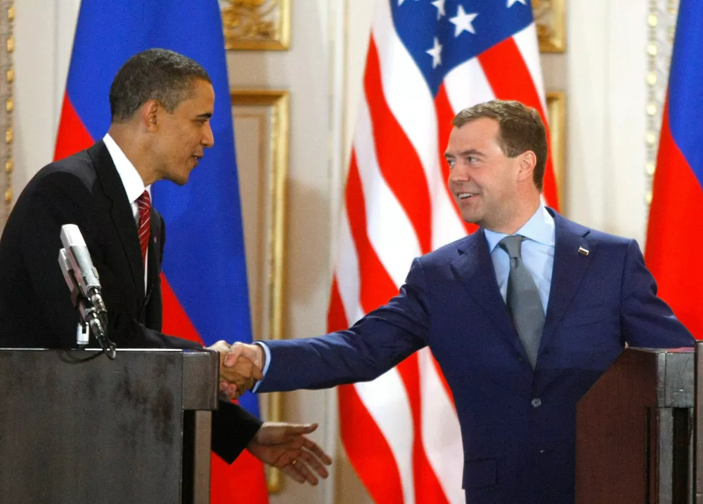 FILE - U.S. President Barack Obama, left, and his Russian counterpart Dmitry Medvedev, right, shake hands at a news conference at the Prague Castle in Prague, Czech Republic,, April 8, 2010, after signing the New START treaty reducing long-range nuclear weapons. (AP Photo/Mikhail Metzel, File)
