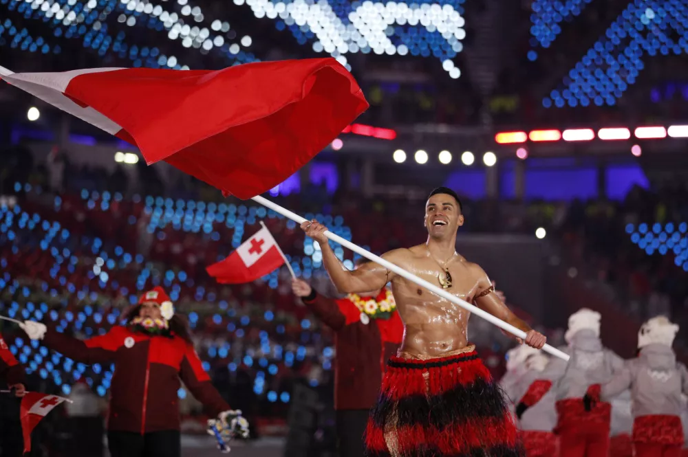 Pita Taufatofua carries the flag of Tonga during the opening ceremony of the 2018 Winter Olympics in Pyeongchang, South Korea, Friday, Feb. 9, 2018. (AP Photo/Jae C. Hong)