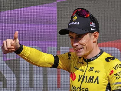 Danish rider Jonas Vingegaard, from Visma | Lease a Bike team celebrates at the podium after wining the ninth stage of La Vuelta from Alfaro to Valdezcaray, Spain, Sunday, Aug. 31, 2025. (AP Photo/Miguel Oses)