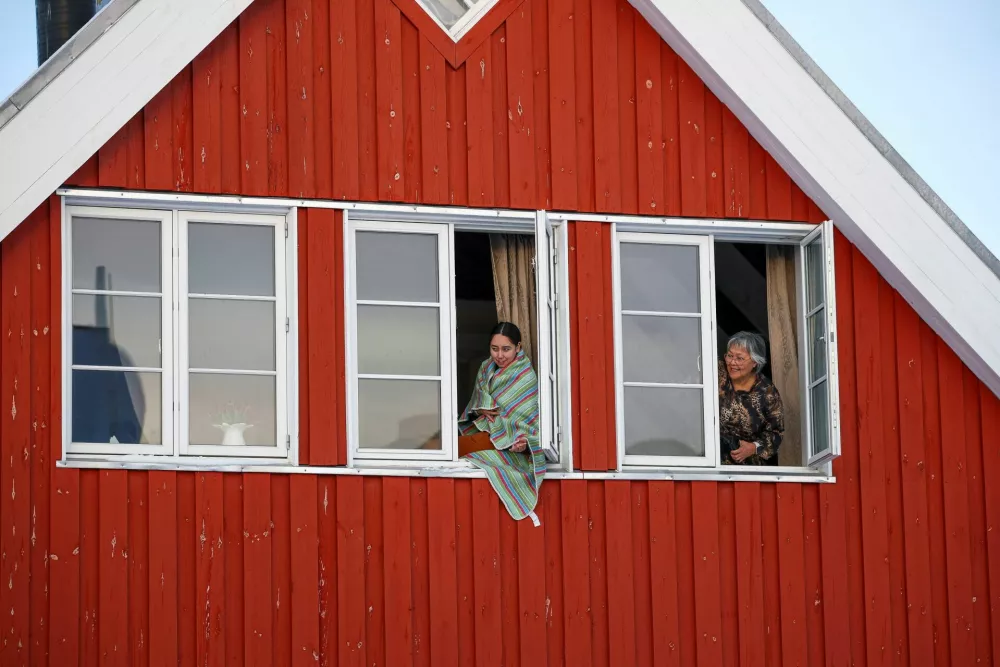 People look out from windows on the day of the official opening of the Canadian Consulate in Nuuk, Greenland, February 6, 2026. REUTERS/Stoyan Nenov