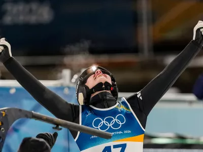 Anna Odine Stroem, of Norway, celebrates after winning the gold medal in the ski jumping women's normal hill individual, at the 2026 Winter Olympics, in Predazzo, Italy, Saturday, Feb. 7, 2026. (AP Photo/Matthias Schrader)