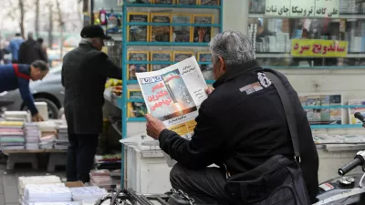 A man reads a newspaper featuring a picture of an Iranian missile, as he sits next to a bookstore, in Tehran, Iran, February 7, 2026. Majid Asgaripour/WANA (West Asia News Agency) via REUTERS ATTENTION EDITORS - THIS PICTURE WAS PROVIDED BY A THIRD PARTY   TPX IMAGES OF THE DAY