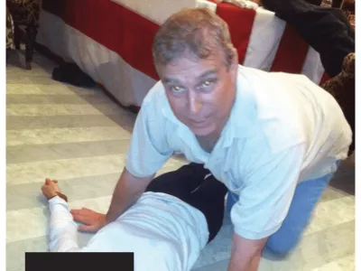 EDS NOTE: GRAPHIC CONTENT - This undated photo, released and redacted by the U.S. Department of Justice as part of the Jeffrey Epstein files, shows Andrew Mountbatten-Windsor, formerly known as Prince Andrew, leaning over an unidentified person. (U.S. Department of Justice via AP)