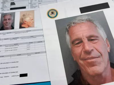 FILE - Documents that were included in the U.S. Department of Justice release of the Jeffrey Epstein files are photographed Friday, Jan. 2, 2026. (AP Photo/Jon Elswick, File)