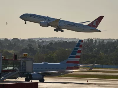 A Turkish Airlines plane takes off alongside an American Airlines plane at Jose Marti International Airport in Havana, Cuba, Monday, Feb. 9, 2026. (AP Photo/Ramon Espinosa)