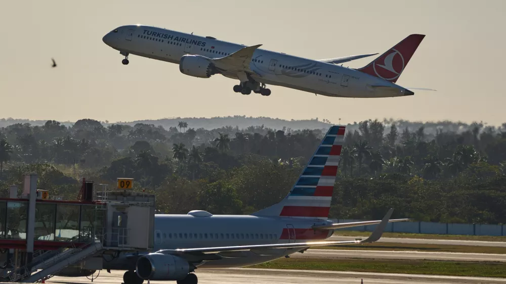A Turkish Airlines plane takes off alongside an American Airlines plane at Jose Marti International Airport in Havana, Cuba, Monday, Feb. 9, 2026. (AP Photo/Ramon Espinosa)