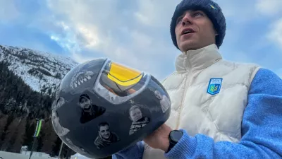 Ukrainian skeleton athlete Vladyslav Heraskevych holds his helmet with images of compatriots killed during the war in Ukraine, at the Milano Cortina Gamesin in Cortina D'Ampezzo, Italy, February 9, 2026. REUTERS/Cristiano Corvino