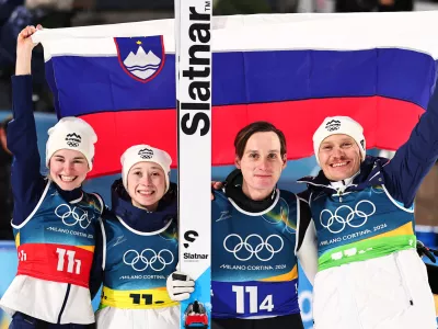 10 February 2026, Italy, Predazzo: (L-R) Slovenia's Nika Vodan, Nika Prevc, Domen Prevc and Anze Lanisek celebrate after the Ski Jumping Mixed team competition of the 2026 Winter Olympic Games at Milan-Cortina. Photo: Daniel Karmann/dpa