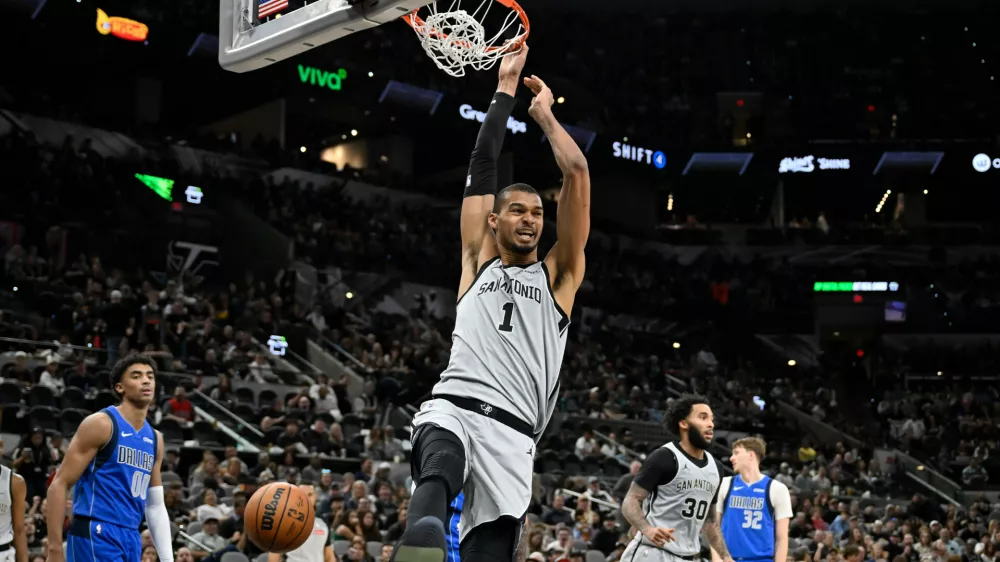 San Antonio Spurs center Victor Wembanyama (1) dunks during the second half of an NBA basketball game against the Dallas Mavericks, Saturday, Feb. 7, 2026, in San Antonio. (AP Photo/Darren Abate)