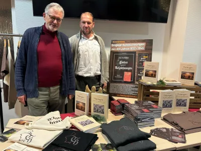 Story from Jam Press (Hitler Notebook Sold)Pictured: Author Olaf Haubold (L) with Thomas Buchzik, the publisher of TYR Verlag in Arnstadt.'G&ouml;ring ate like a pig!' 'Hitler's notebook' sells for Ł26k after being found in atticA diary believed to have been written by Adolf Hitler has been found in an attic and sold for around Ł26,000.It has 113 handwritten pages with references to high-ranking Nazi official Hermann G&ouml;ring and German Hollywood star Marlene Dietrich.In the notebook, Hitler allegedly declared his love for the German actress.This book offers lots of material for speculation, but it has yet to be authenticated as being written by the Nazi leader.An expert at least confirmed that the paper dates from the period.The notebook was first offered to author Olaf Haubold, 74, who was unable to match the seller's asking price.He then brokered a deal with a collector he knew, who ended up paying a reported fee of around Ł26,000 (&euro;30,000).Olaf, who lives in Thuringia, told What's The Jam: "In 2008, an elderly gentleman came to my office and offered me documents from Adolf Hitler's estate."It seemed suspicious to me at first, but I asked him to show me a sample."He then came with a notebook and several documents that initially appeared to be authentic."Because I lack expertise in this area, I sought help from historians, and we concluded that there was a possibility of its authenticity."But the asking price was too high for me, given the uncertainties."At the time, I knew a wealthy collector who had also sponsored some of my projects."He was prepared to pay the asking price for the entire collection."I don't know the exact fee, the price mentioned in reports is an estimate."The seller said he found the notebook in an attic, but Olaf wasn't convinced that part was true.He said: "The gentleman who offered the collection didn't want to say anything about its origin."The 'attic find' explanation was too vague for us."Some documents bear stamps of the Ministry for State Security of the former GDR, otherwise known as the Stasi."It's possible it came from somewhere like that."After brokering the sale, Olaf secured the rights to use the collection for his 2025 book 'The Collection &ndash; Hitler's Secret Records'.He was granted permission to analyse the material with East German writer Martin Stade before his death in 2018.The buyer has also passed away since procuring the notebook, and it is now owned by his children.Olaf said: "I only have the publication rights from the collector and now from his heirs."The collection is still complete and has not yet been offered publicly at auction or in any other way."The notebook is old; whether it contains Hitler's handwriting is unproven."Despite the uncertainties, I decided to publish the material."The esteemed reader may form their own opinion."In his own opinion, Olaf said it's "very likely" the work was produced by Hitler's hand.In the first pages, Hitler is quoted as criticising the Reich Chancellery before moving in."The building is in a state of complete decay. Ceiling and floor are rotten. Wallpaper and flooring are decayed."The highlight was a bath in the bathroom. Should I bathe in everyone's sewage? Never!"After a birthday party, he is said to have written the following about his deputy: "G&ouml;ring ate like a pig again."And about Marlene Dietrich, he said: "I have to try to bring her back to Germany."I've had all of Dietrich's new films sent to me."I think I've fallen in love with her."Eva doesn't stand a chance against Dietrich."But I won't let on. The woman has to come to Germany, even if it's by force. I'll set the intelligence service on her."Dietrich is hanging around with the Americans now. I'll write her another letter."The best thing would be to offer her money. Women will do anything for money, you can see that with Eva."I'll use Eva as a test subject and study her behaviour."I'm going to make Dietrich a money offer and see if she takes the bait."So, let's get to work. Because I am the F&uuml;hrer."The secret service says it won't be so easy to get hold of Dietrich."What is easy anyway! I told them to put in the effort. I want to see results."That's what they're paid for, and not badly at that."It's not the first time a journal has been attributed to Adolf Hitler.In 1983, the German magazine Stern bought the 'Hitler Diaries', a series of 60 volumes of journals allegedly written by the Nazi leader.But they were later found to have been forged and two men were convicted of defrauding Stern of 9.3 million Deutsche Marks, about Ł2.3 million.The case provided the basis for the 1992 film Schtonk!'ENDS,Image: 1067280549, License: Rights-managed, Restrictions:, Model Release: no