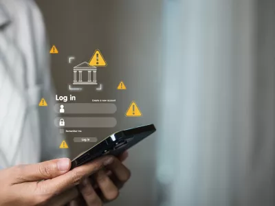 Business professional holding smartphone with bank login screen and yellow warning iconsconcept of mobile banking alert, phishing risk, account security, two-factor authentication, fraud prevention.