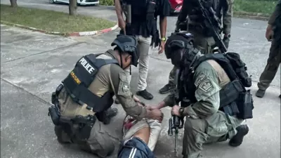 This photo released by the Royal Thai Police, shows Thai police arresting a man at Patongprathankiriwat School in Hat Yai, Songkhla province, Thailand, Wednesday, Feb. 11, 2026. (Royal Thai Police via AP)