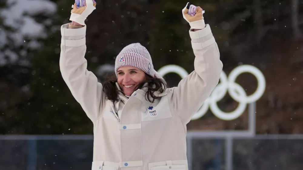Julia Simon, of France, celebrates gold during a medals ceremony for the women's 15-kilometer individual biathlon race at the 2026 Winter Olympics in Anterselva, Italy, Wednesday, Feb. 11, 2026. (AP Photo/Andrew Medichini)