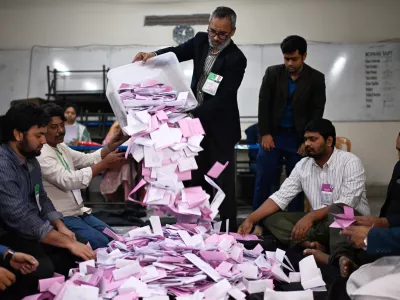 Polling officials begin the counting of votes cast for the national parliamentary election in Dhaka, Bangladesh, Thursday, Feb. 12, 2026. (AP Photo/Mahmud Hossain Opu)