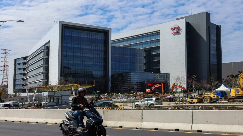 A man rides past an under-construction fabrication plant of 2-nanometer semiconductors for TSMC or Taiwan Semiconductor Manufacturing Corp., a Taiwanese multinational semiconductor contract manufacturing and design company, in Hsinchu, Taiwan, on Thursday, Jan. 29, 2026. (AP Photo/Daniel Ceng)