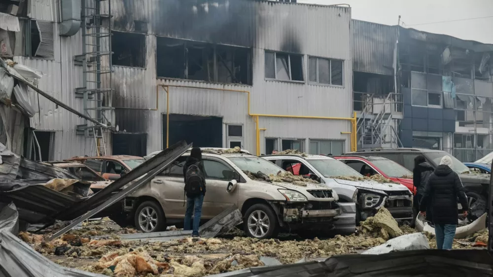 Residents inspect damaged cars at the site of a Russian drone strike, amid Russia's attack on Ukraine, in Odesa, Ukraine February 13, 2026. REUTERS/Nina Liashonok