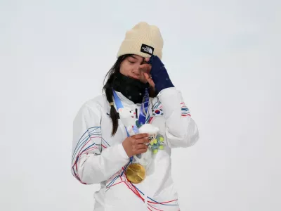 Milano Cortina 2026 Olympics - Snowboard - Women's Snowboard Halfpipe Victory Ceremony - Livigno Snow Park, Livigno, Italy - February 12, 2026. Gold medallist Gaon Choi of South Korea reacts on the podium after winning the Women's Snowboard Halfpipe. REUTERS/Hannah Mckay