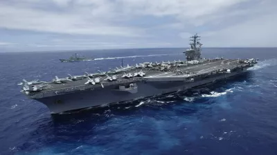 The USS Nimitz, a nuclear-powered aircraft carrier which is currently supplemented by biofuel, sails about 150 miles north of the island of Oahu during the RIMPAC Naval exercises off Hawaii in this file photo from July 18,2012. The Nimitz and four other ships in its strike group moved into the Red Sea early September 1, 2013, U.S. defense officials said, describing the move as "prudent planning" in case the ships are needed for military action against Syria. REUTERS/Hugh Gentry/Files (UNITED STATES - Tags: MILITARY ENERGY BUSINESS MARITIME ENVIRONMENT)