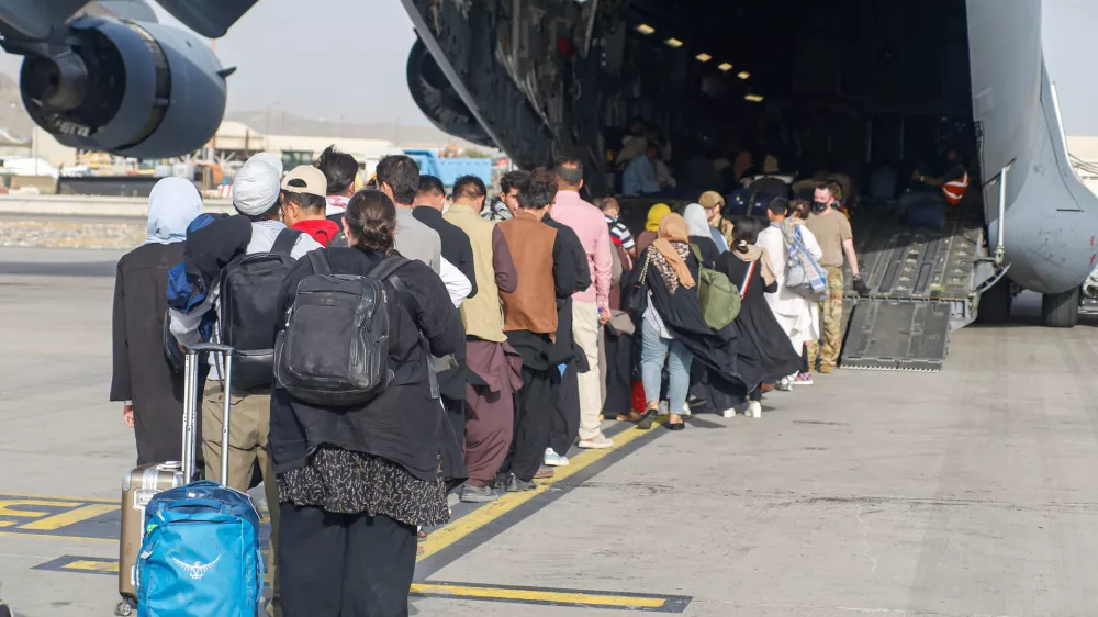 Evacuees assemble before boarding a C-17 Globemaster III during an evacuation at Hamid Karzai International Airport, Afghanistan, August 18, 2021. Picture taken August 18, 2021. U.S. Marine Corps/Lance Cpl. Nicholas Guevara/Handout via REUTERS THIS IMAGE HAS BEEN SUPPLIED BY A THIRD PARTY.