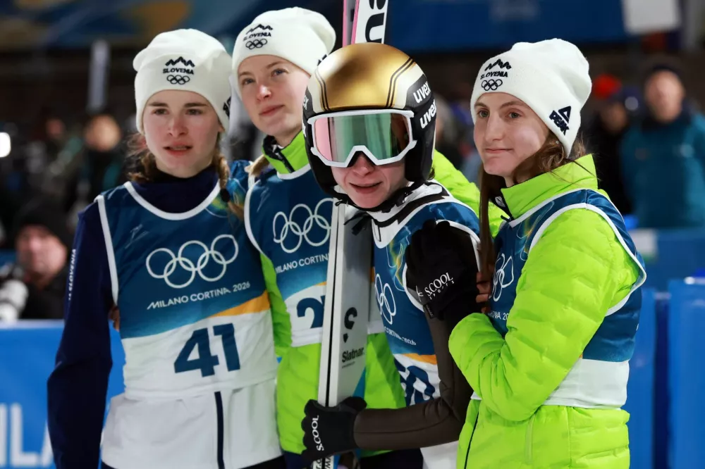 Milano Cortina 2026 Olympics - Ski Jumping - Women's Large Hill Individual - Predazzo Ski Jumping Stadium, Predazzo, Italy - February 15, 2026. Nika Prevc of Slovenia, Nika Vodan of Slovenia, Katra Komar of Slovenia, and Maja Kovacic of Slovenia react during the final round REUTERS/Stephanie Lecocq